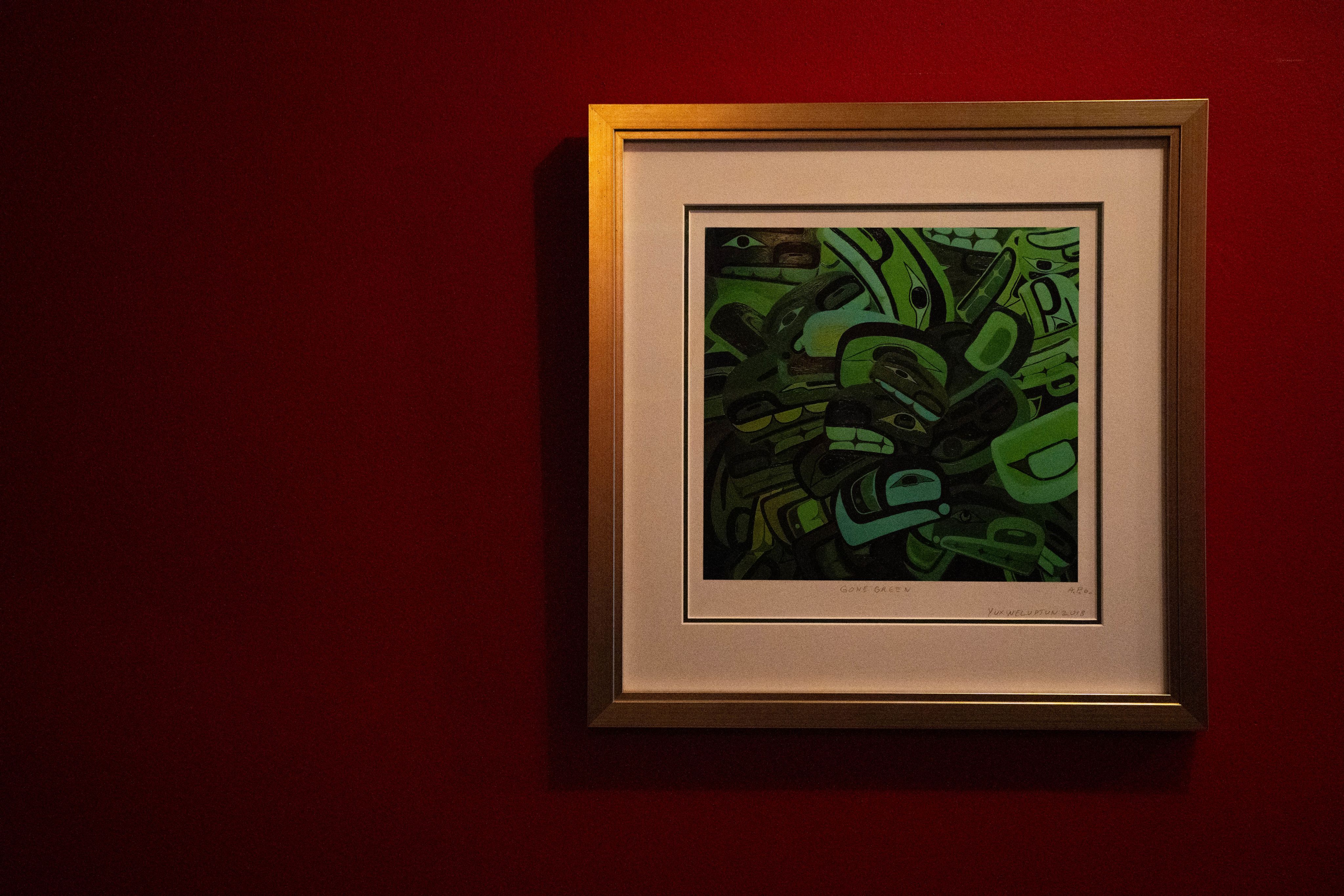 A painting—'Gone Green' by Lawrence Paul Yuxweluptun—on a wall at Salmon n' Bannock