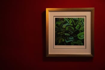 A painting—'Gone Green' by Lawrence Paul Yuxweluptun—on a wall at Salmon n' Bannock